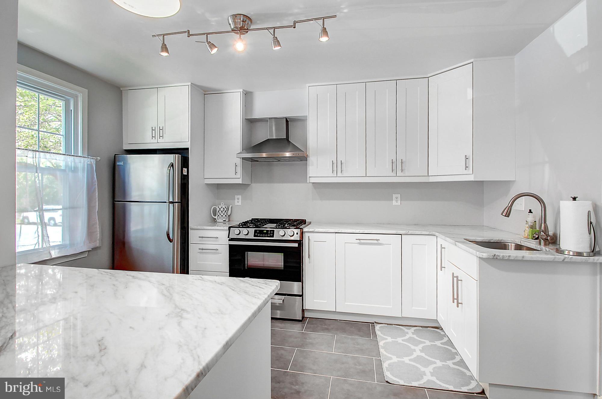7222 Brookfalls Terrace Baltimore, MD 21209 - Photo 8 of 29 a kitchen with stainless steel appliances granite countertop a refrigerator stove sink and cabinets