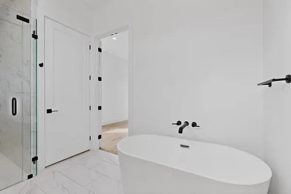 an empty room with a window and a ceiling fan