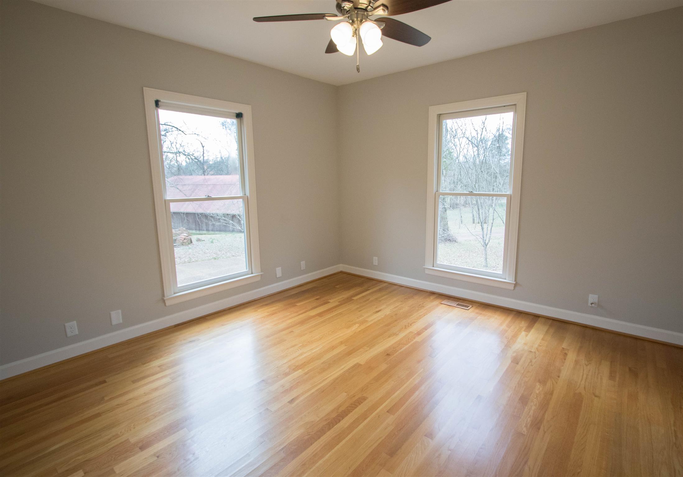 4304 Warren Road Franklin, TN 37067 - Photo 13 of 30 a view of an empty room with wooden floor and a window