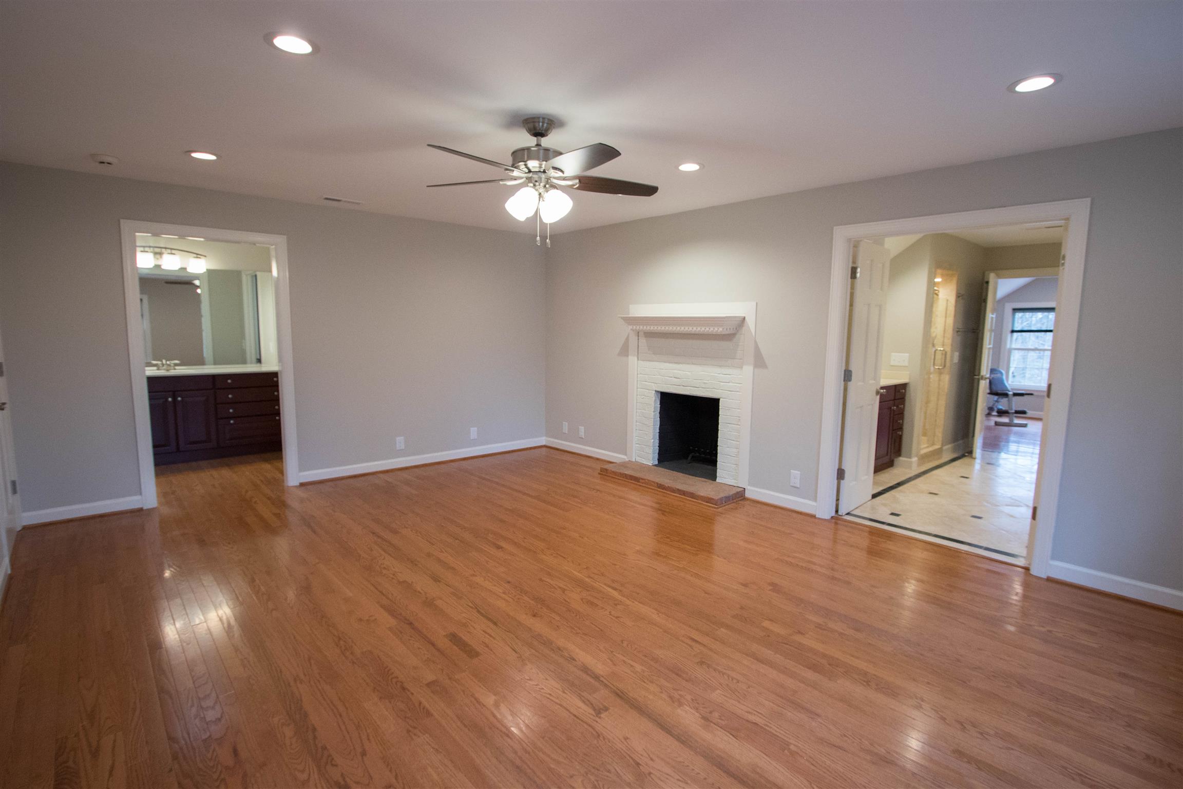 4304 Warren Road Franklin, TN 37067 - Photo 19 of 30 a view of an empty room with wooden floor and a ceiling fan