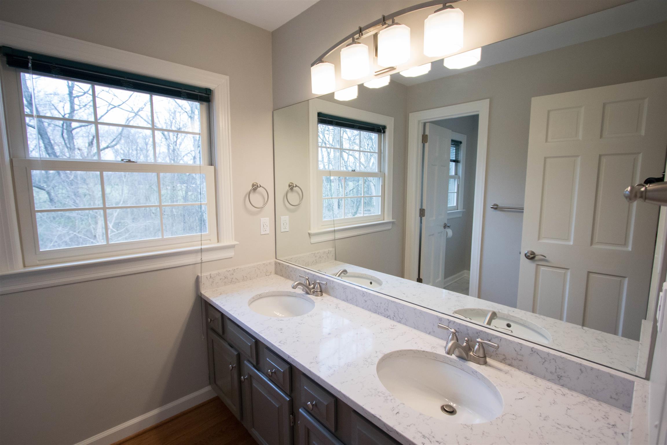 4304 Warren Road Franklin, TN 37067 - Photo 24 of 30 a bathroom with a double vanity sink window and a mirror