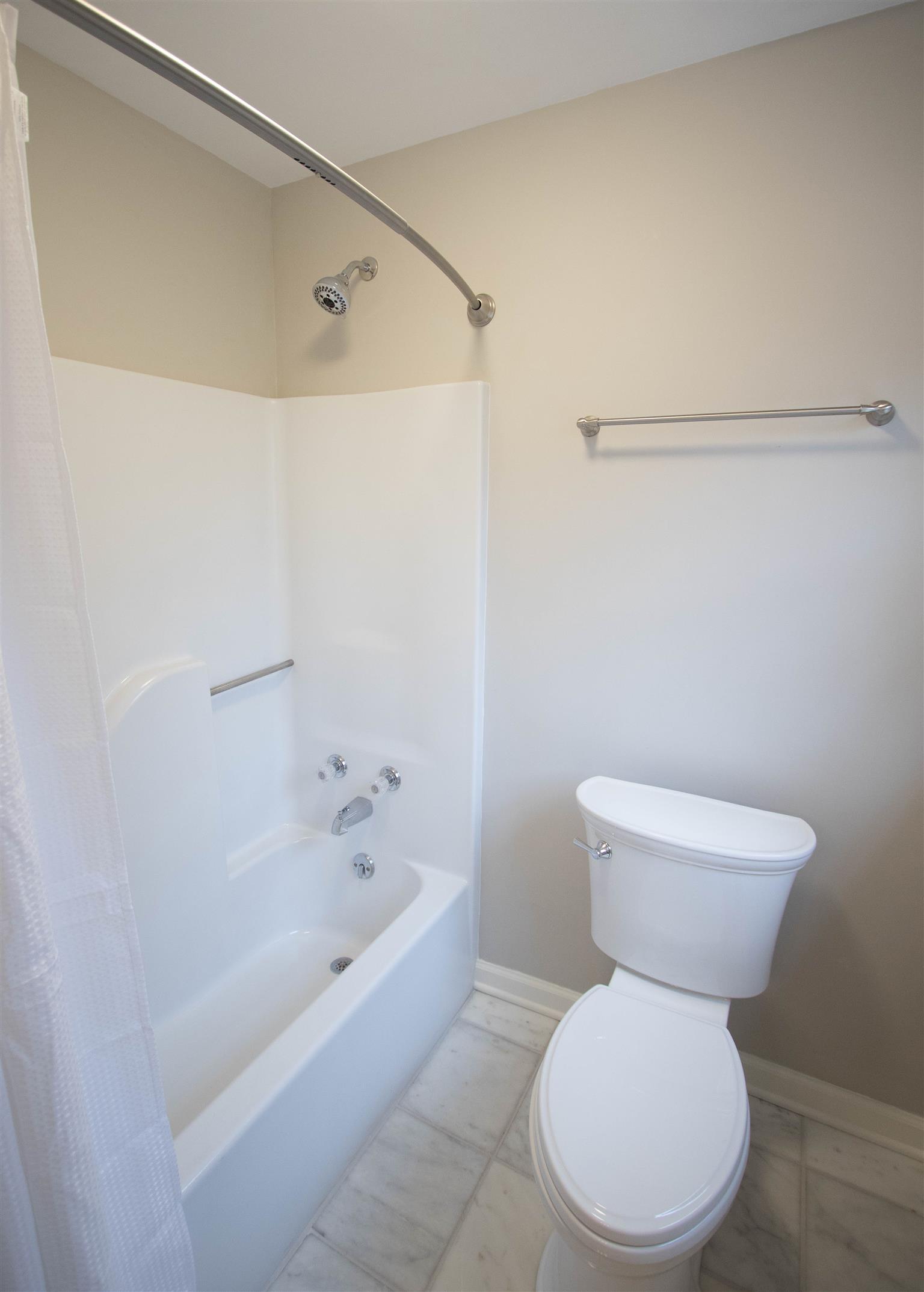 4304 Warren Road Franklin, TN 37067 - Photo 25 of 30 a white toilet sitting next to a bathtub