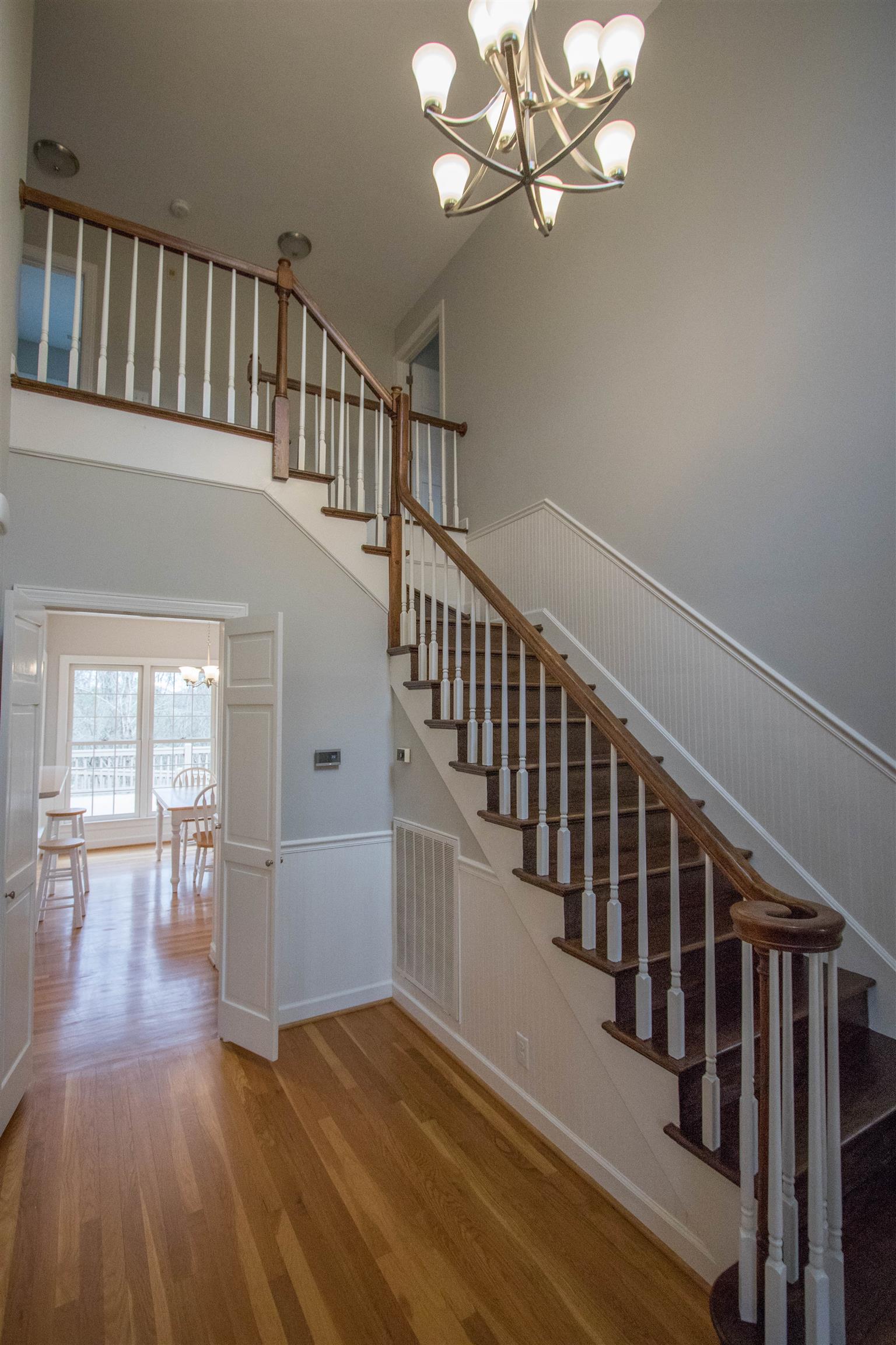 4304 Warren Road Franklin, TN 37067 - Photo 4 of 30 a view of staircase with wooden floor and a chandelier