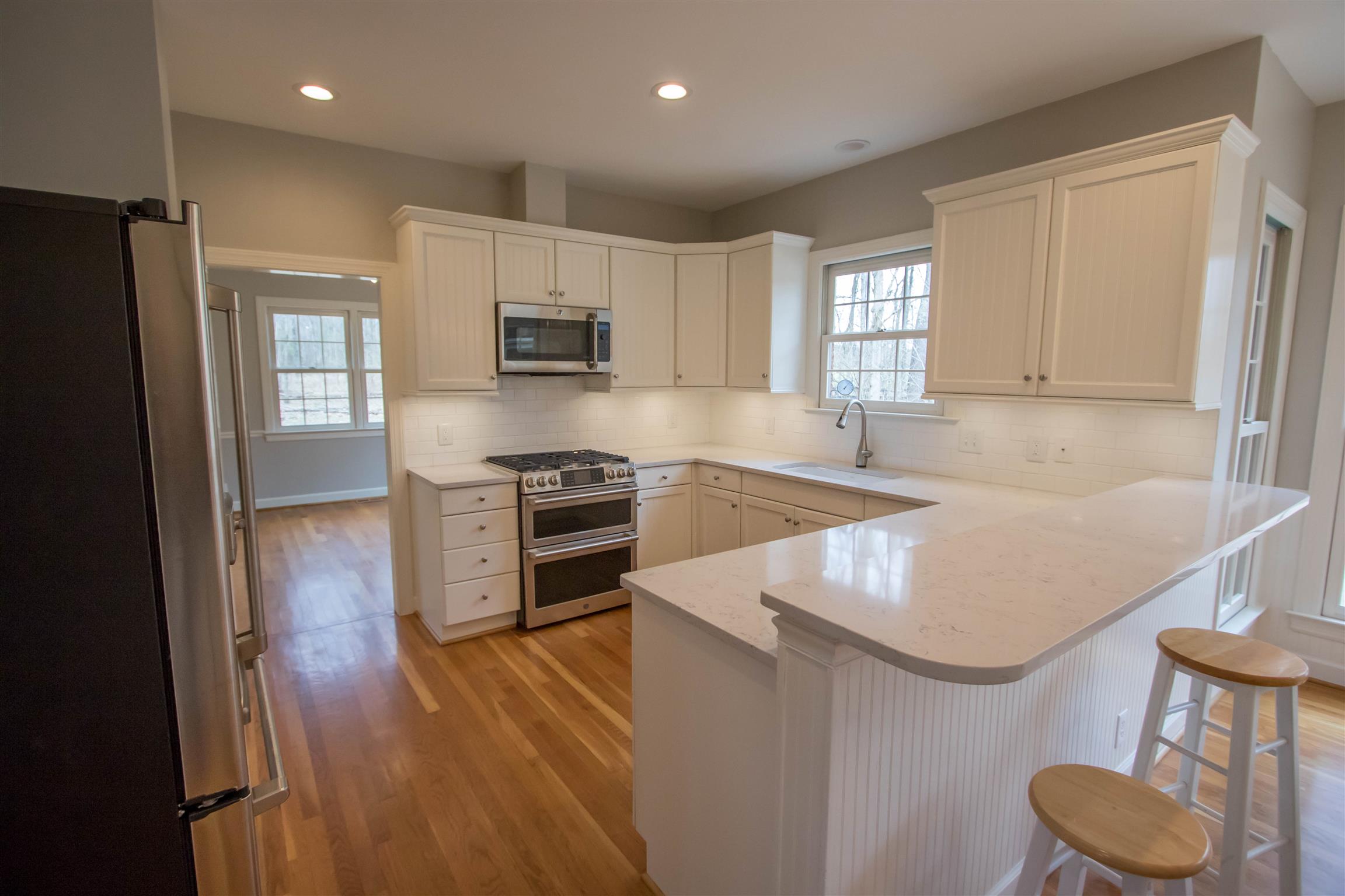 4304 Warren Road Franklin, TN 37067 - Photo 8 of 30 a kitchen with granite countertop a stove a sink and a refrigerator