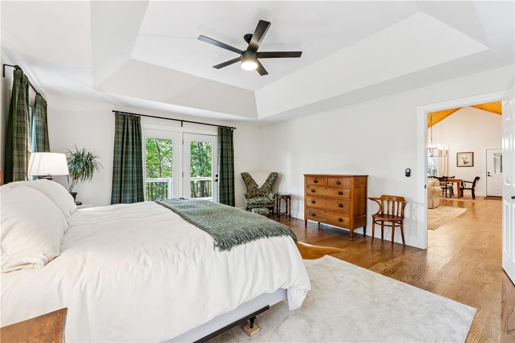 43 Morgan Walk Jasper, GA 30143 - Photo 17 of 55 a spacious bedroom with a bed a table and a chandelier