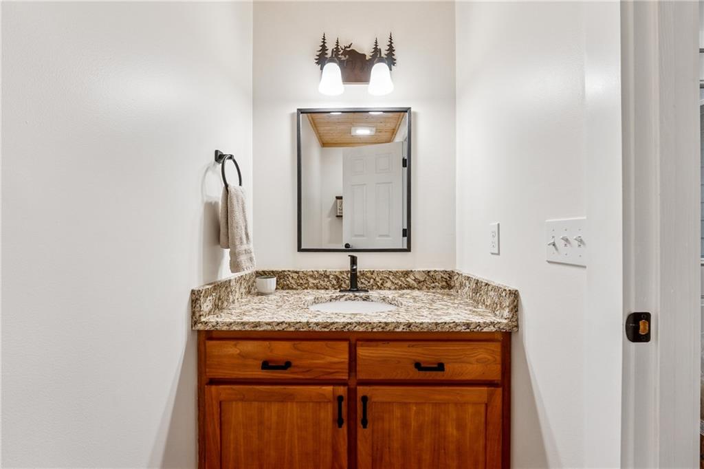 43 Morgan Walk Jasper, GA 30143 - Photo 24 of 55 a bathroom with a granite countertop sink and a mirror