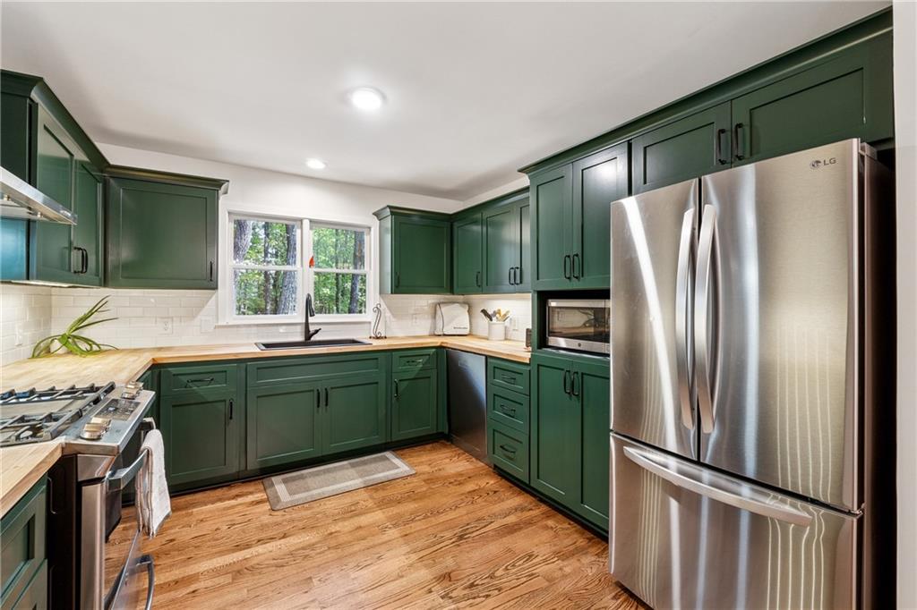 43 Morgan Walk Jasper, GA 30143 - Photo 10 of 55 a kitchen with stainless steel appliances granite countertop a refrigerator and a sink