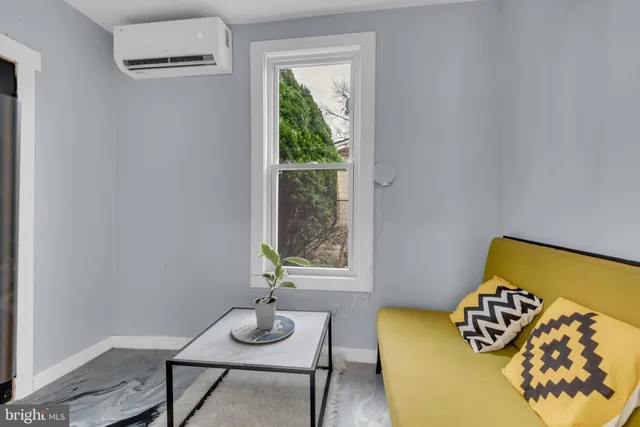 a view of a livingroom with furniture and a window