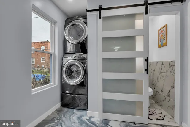 a view of storage and utility room with washer and dryer