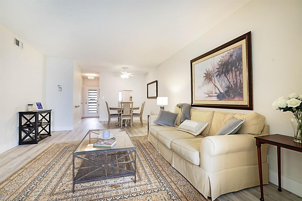 1951 Northeast 39th Street, Unit 343 Lighthouse Point, FL 33064 - Photo 14 of 28 a living room with furniture and wooden floor
