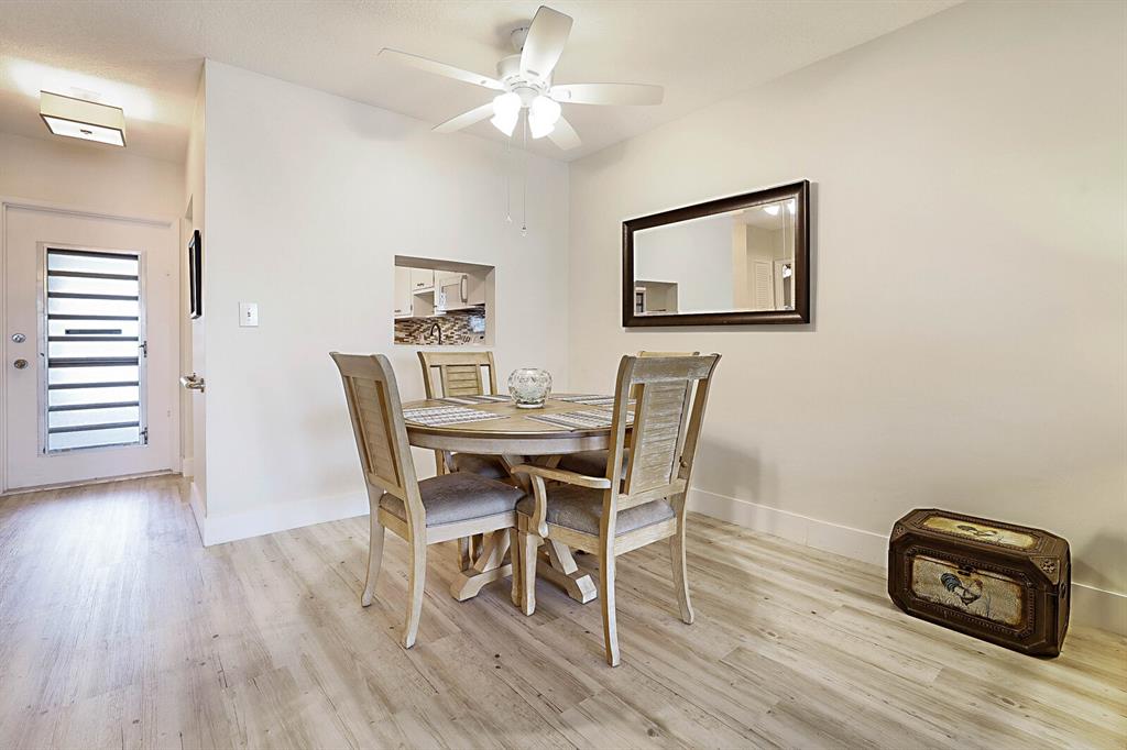 1951 Northeast 39th Street, Unit 343 Lighthouse Point, FL 33064 - Photo 15 of 28 a view of a dining room with furniture and wooden floor
