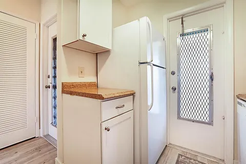 a kitchen with a refrigerator and a stove