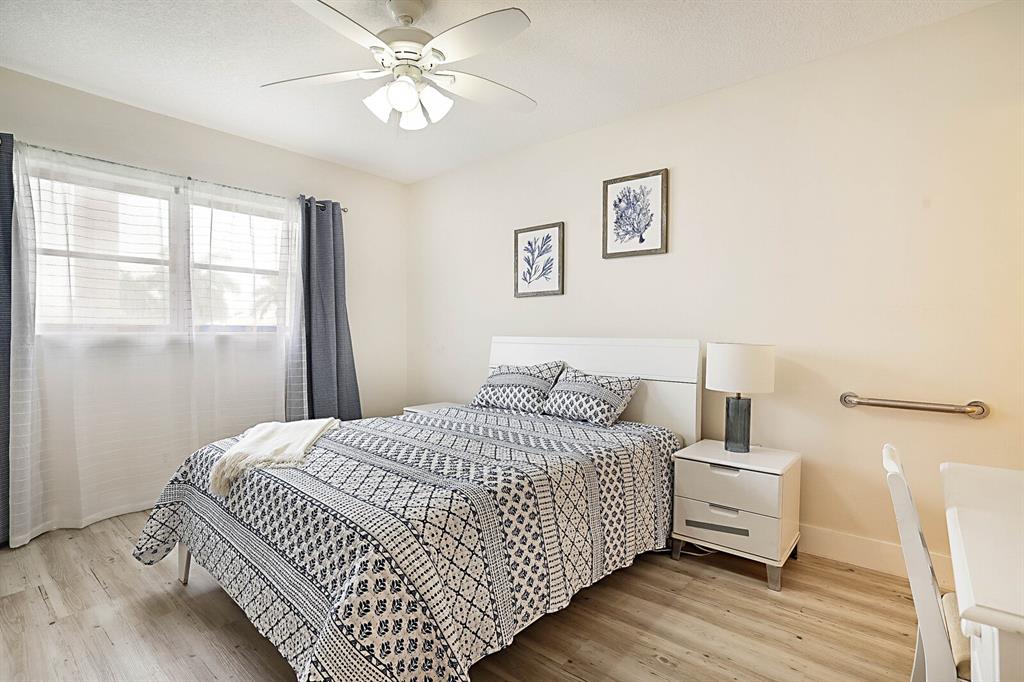 1951 Northeast 39th Street, Unit 343 Lighthouse Point, FL 33064 - Photo 18 of 28 a bedroom with a bed and a window