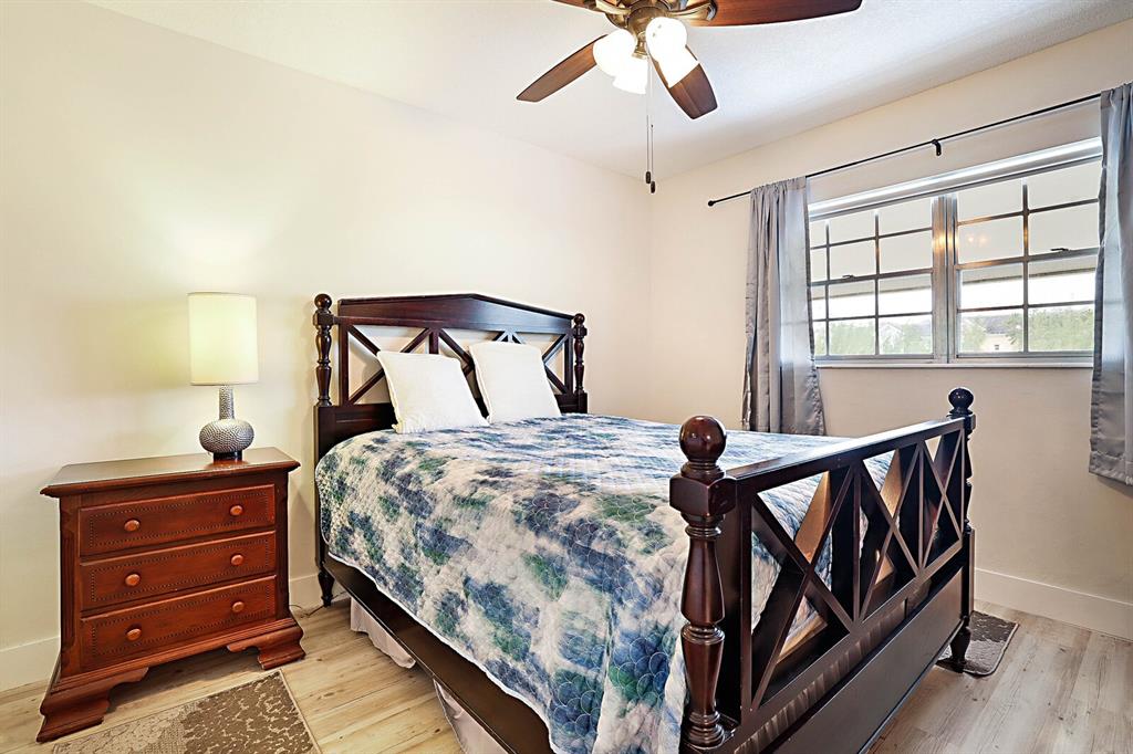 1951 Northeast 39th Street, Unit 343 Lighthouse Point, FL 33064 - Photo 22 of 28 a bedroom with a bed and wooden floor