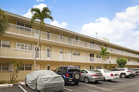 a couple of cars parked in front of a building
