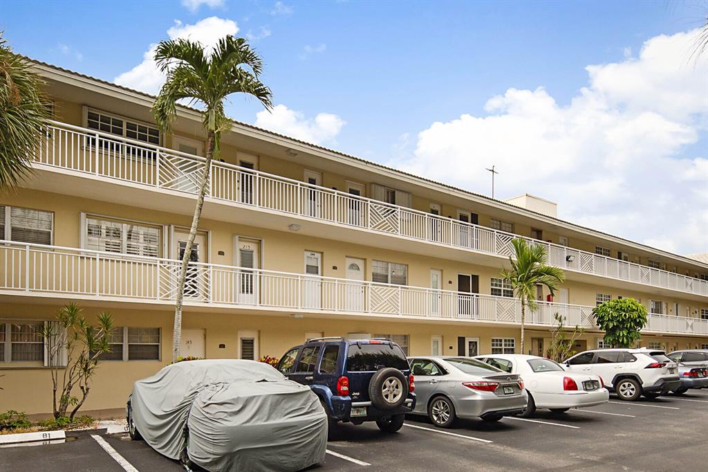 1951 Northeast 39th Street, Unit 343 Lighthouse Point, FL 33064 - Photo 25 of 28 a couple of cars parked in front of a building