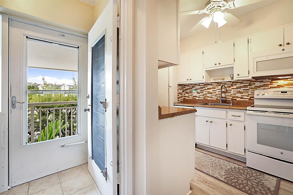 1951 Northeast 39th Street, Unit 343 Lighthouse Point, FL 33064 - Photo 6 of 28 a kitchen with white cabinets and window