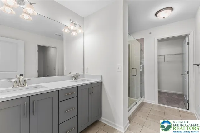 a bathroom with a double vanity sink and mirror