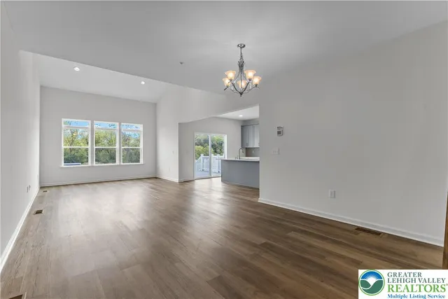 a view of livingroom with kitchen and hardwood