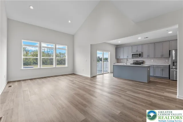 a view of kitchen with wooden floor and electronic appliances