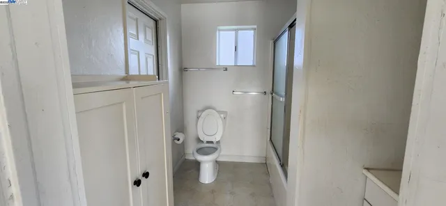 a bathroom with a granite countertop shower and a sink