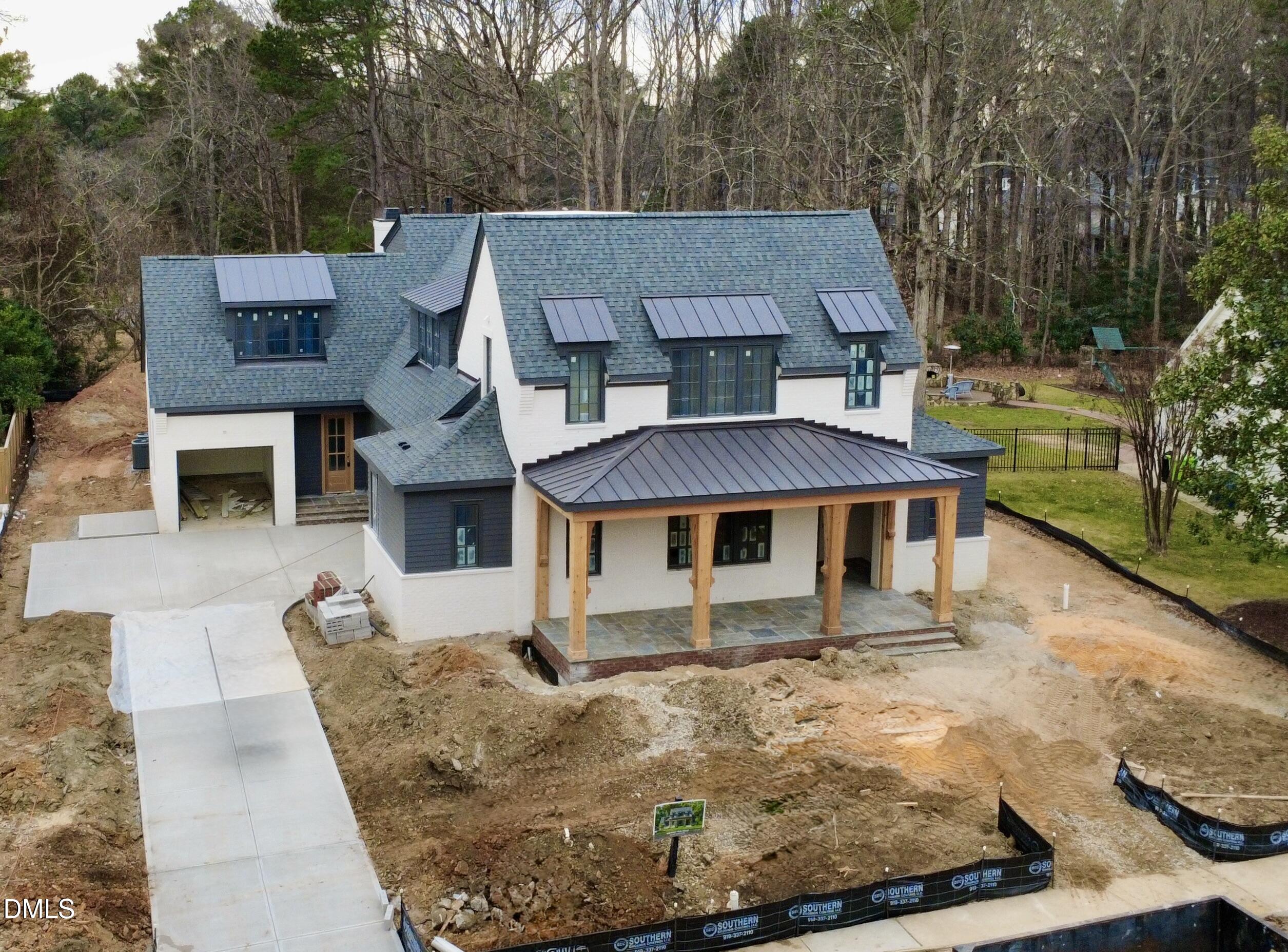 a view of a house with backyard porch and sitting area