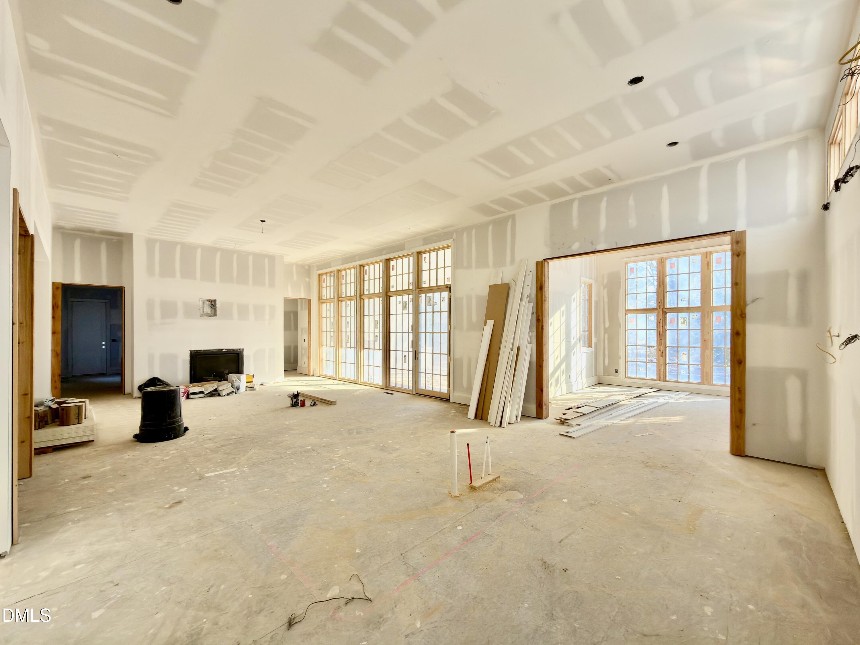 1412 Pony Run Road Raleigh, NC 27615 - Photo 11 of 42 a view of an empty room with a fireplace and a large window