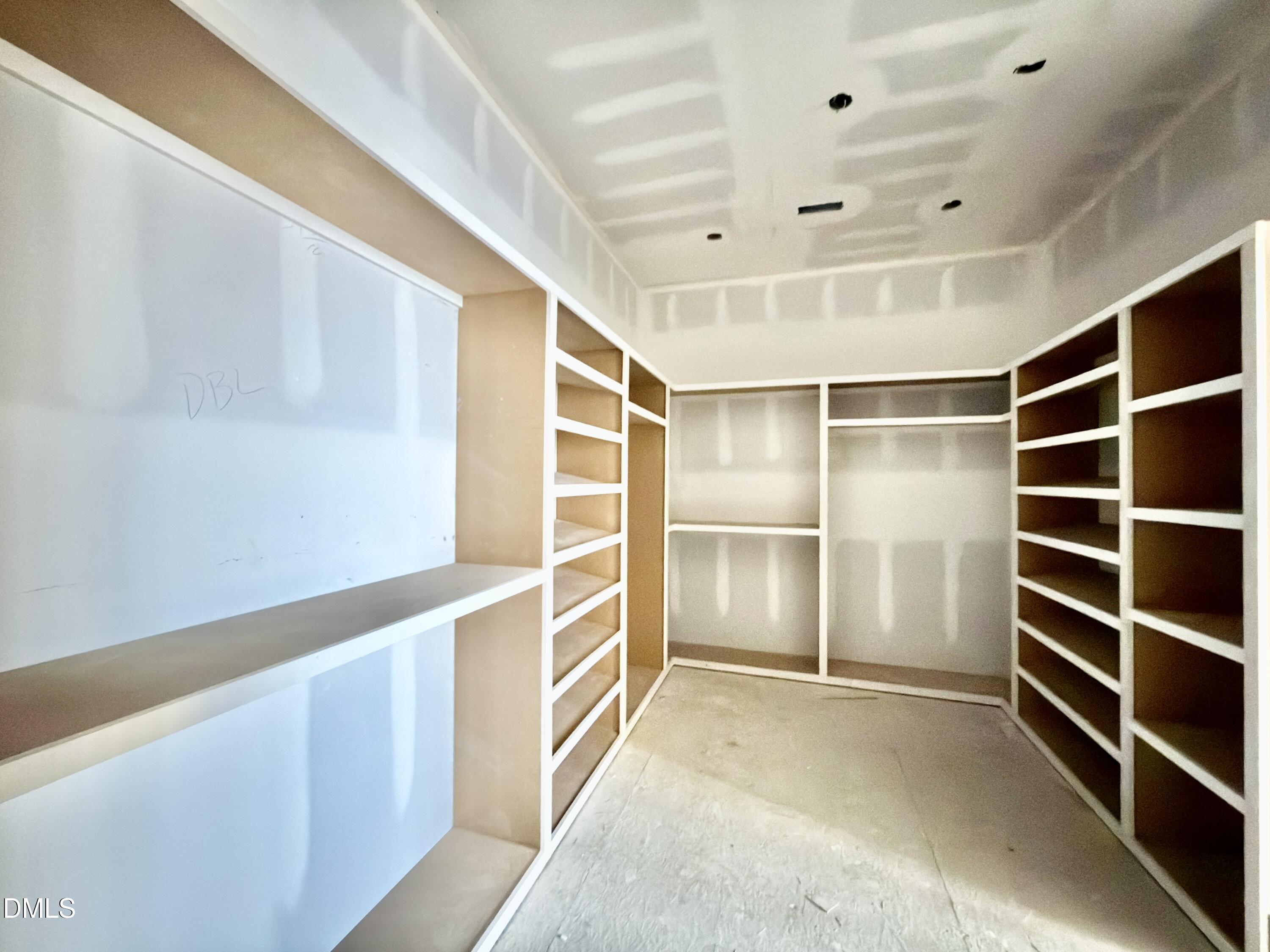 1412 Pony Run Road Raleigh, NC 27615 - Photo 18 of 42 a view of walk in closet with empty racks