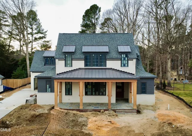 a front view of a house with swimming pool and porch