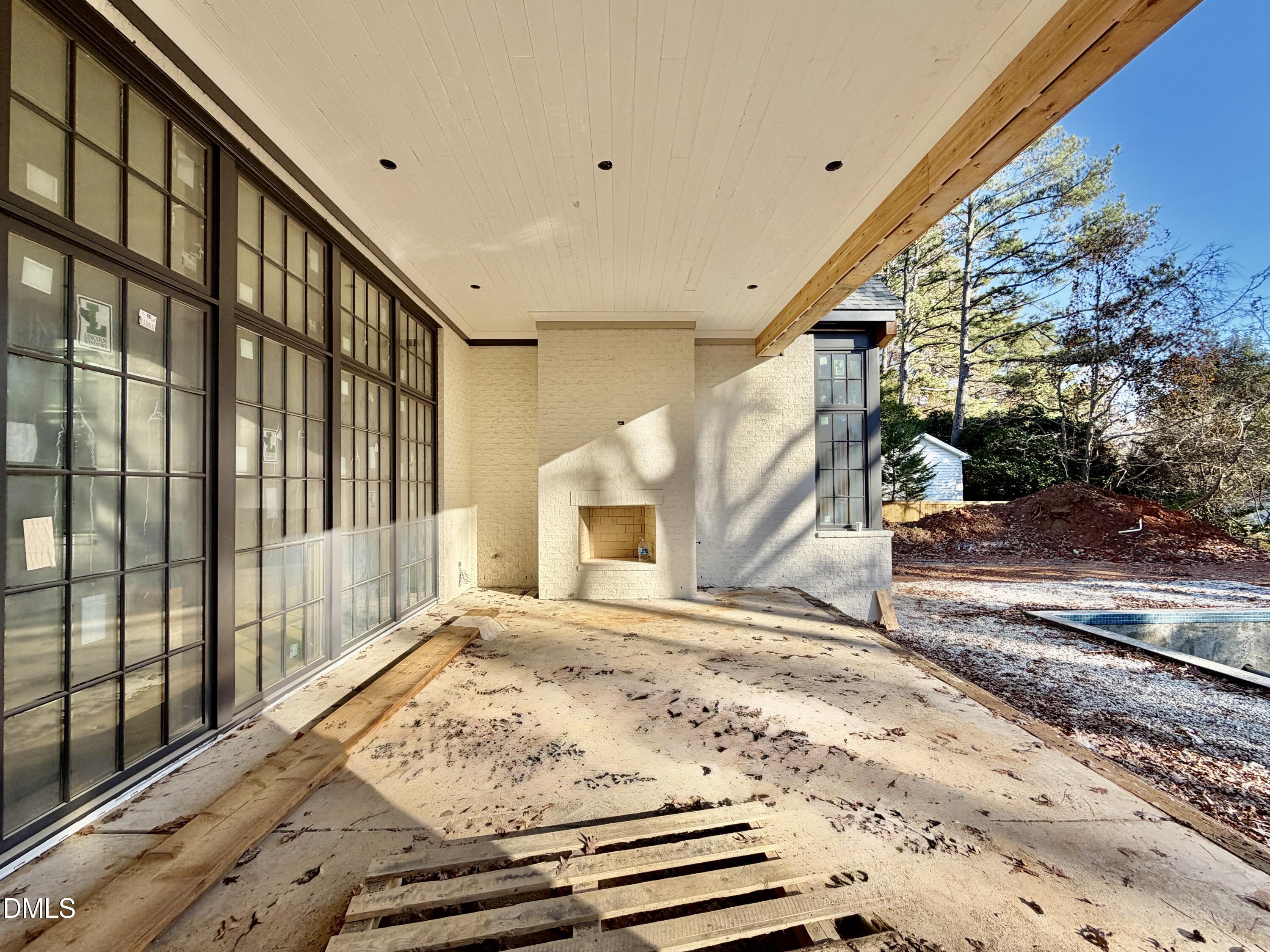 1412 Pony Run Road Raleigh, NC 27615 - Photo 23 of 42 a view of a porch with a floor to ceiling window and wooden floor