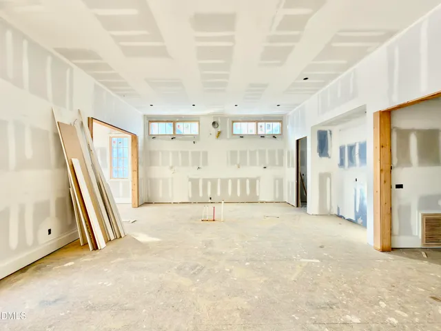 a view of a porch with a floor to ceiling window and wooden floor