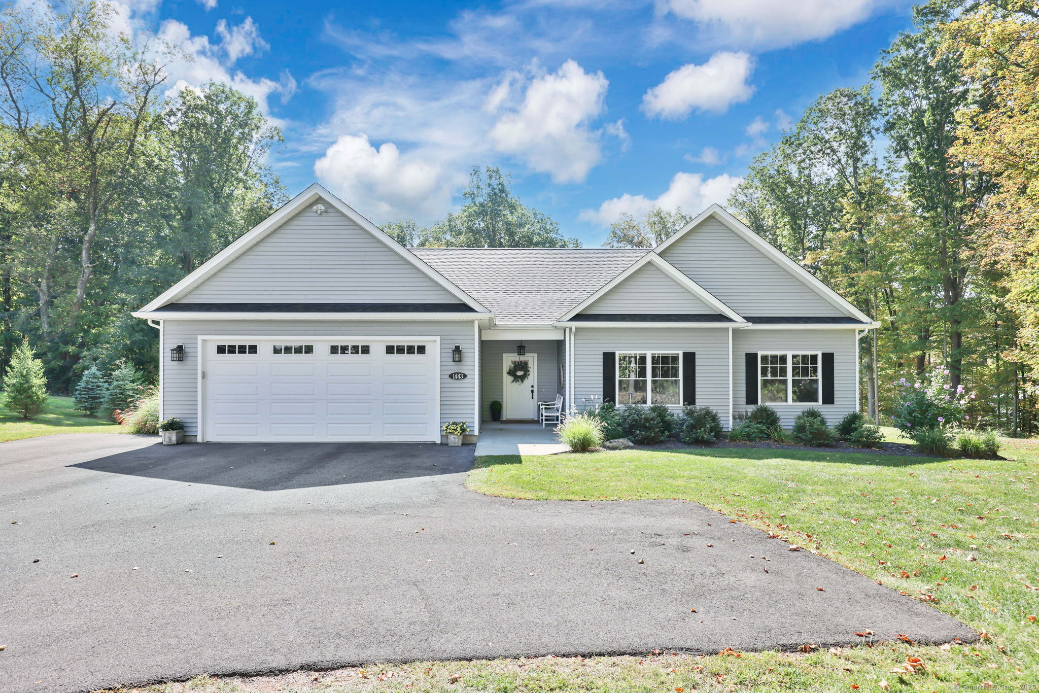 a view of a house with a yard and large tree
