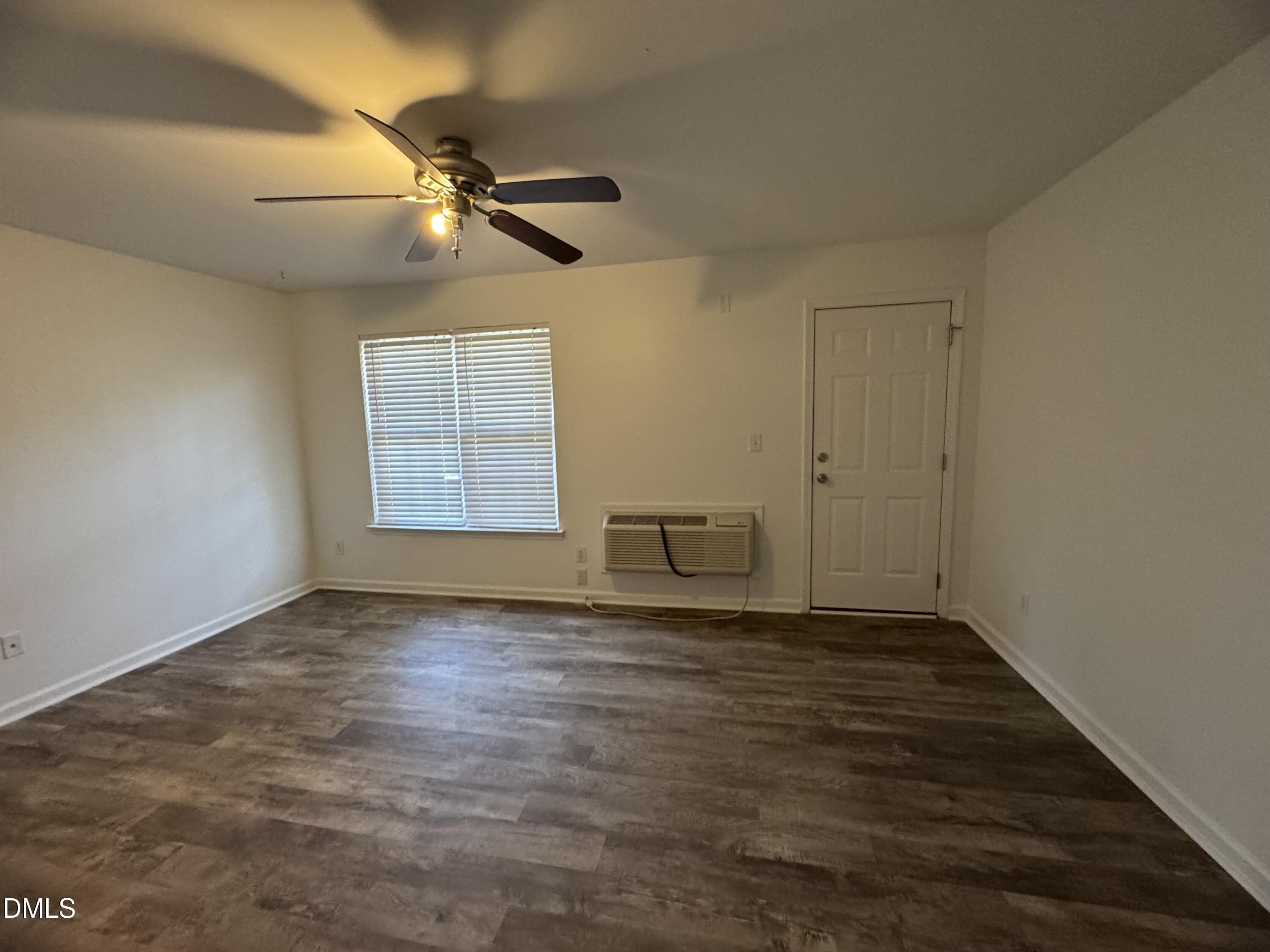 2212 Persimmon Ridge Drive Raleigh, NC 27604 - Photo 12 of 20 an empty room with wooden floor fan and windows
