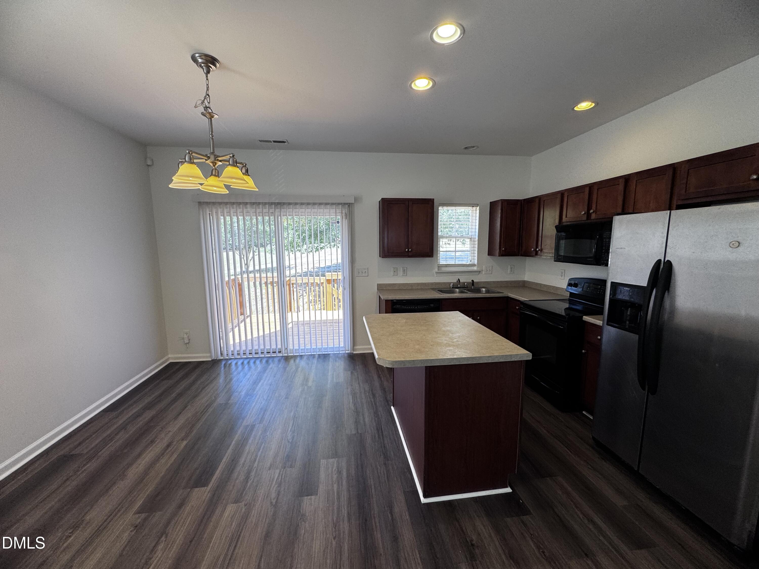 2212 Persimmon Ridge Drive Raleigh, NC 27604 - Photo 6 of 20 a kitchen with stainless steel appliances a stove sink and wooden floor