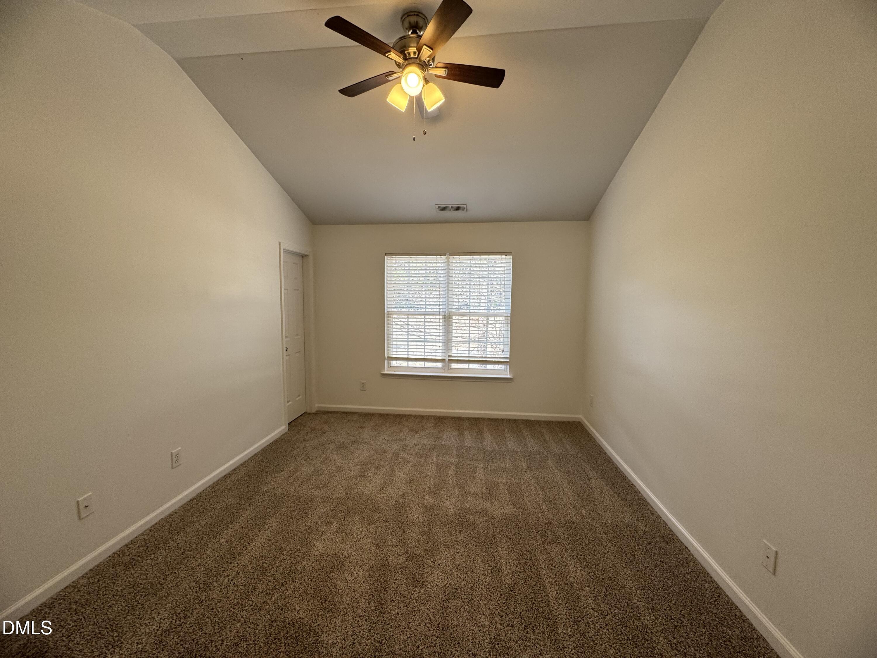 2212 Persimmon Ridge Drive Raleigh, NC 27604 - Photo 7 of 20 an empty room with a window and a fan