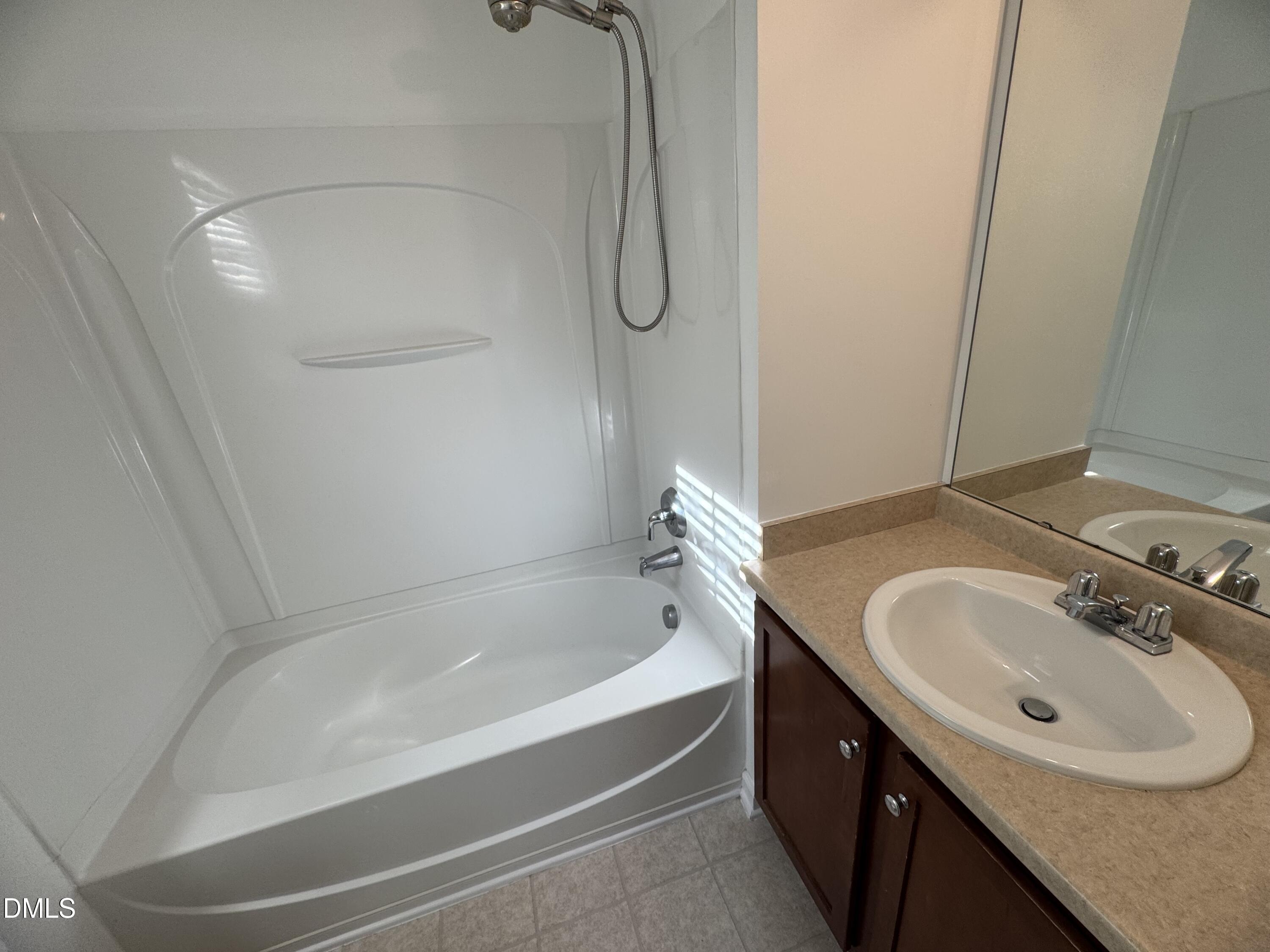 2212 Persimmon Ridge Drive Raleigh, NC 27604 - Photo 8 of 20 a bathroom with a tub sink vanity and mirror