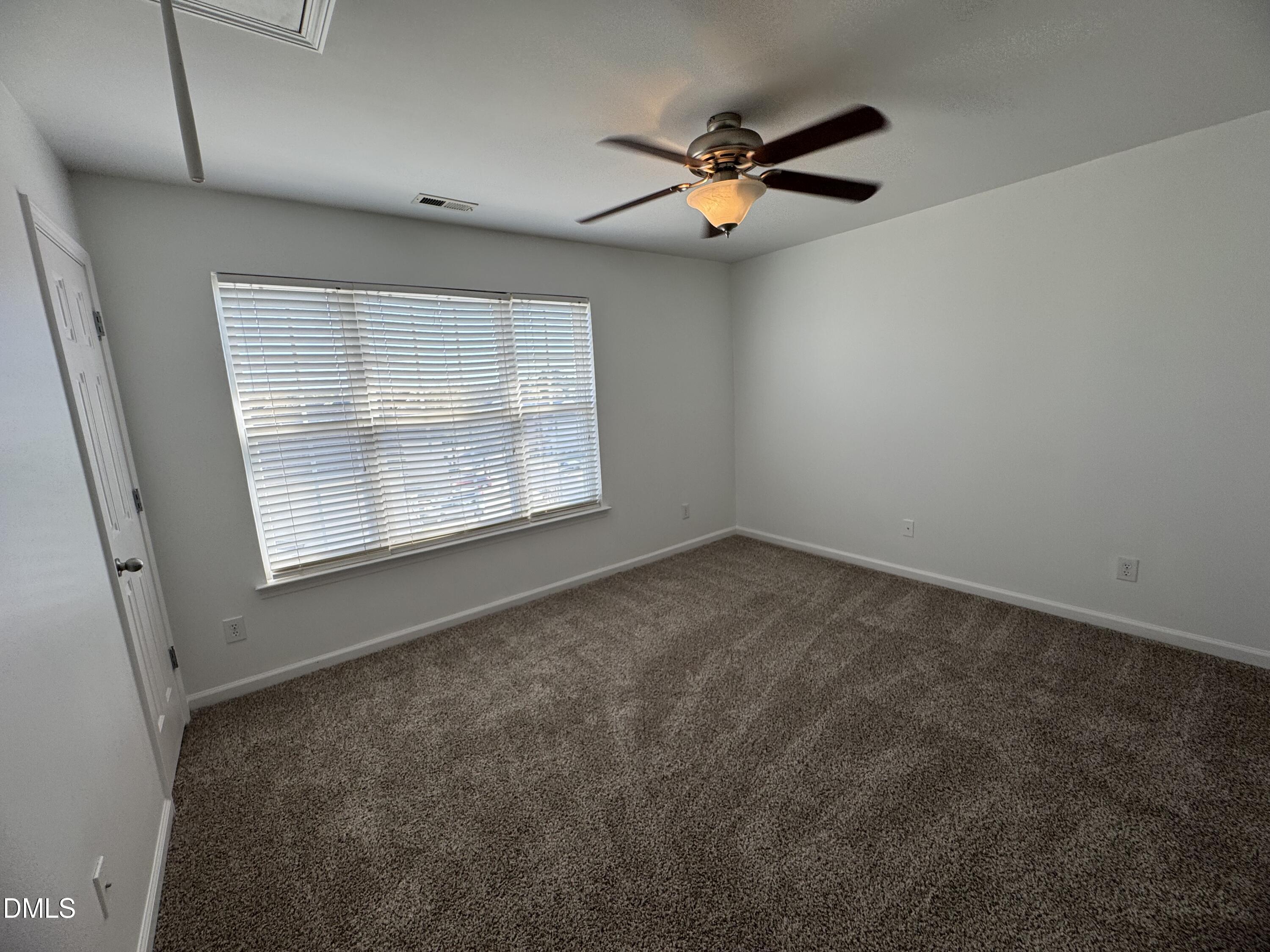 2212 Persimmon Ridge Drive Raleigh, NC 27604 - Photo 9 of 20 an empty room with windows and fan