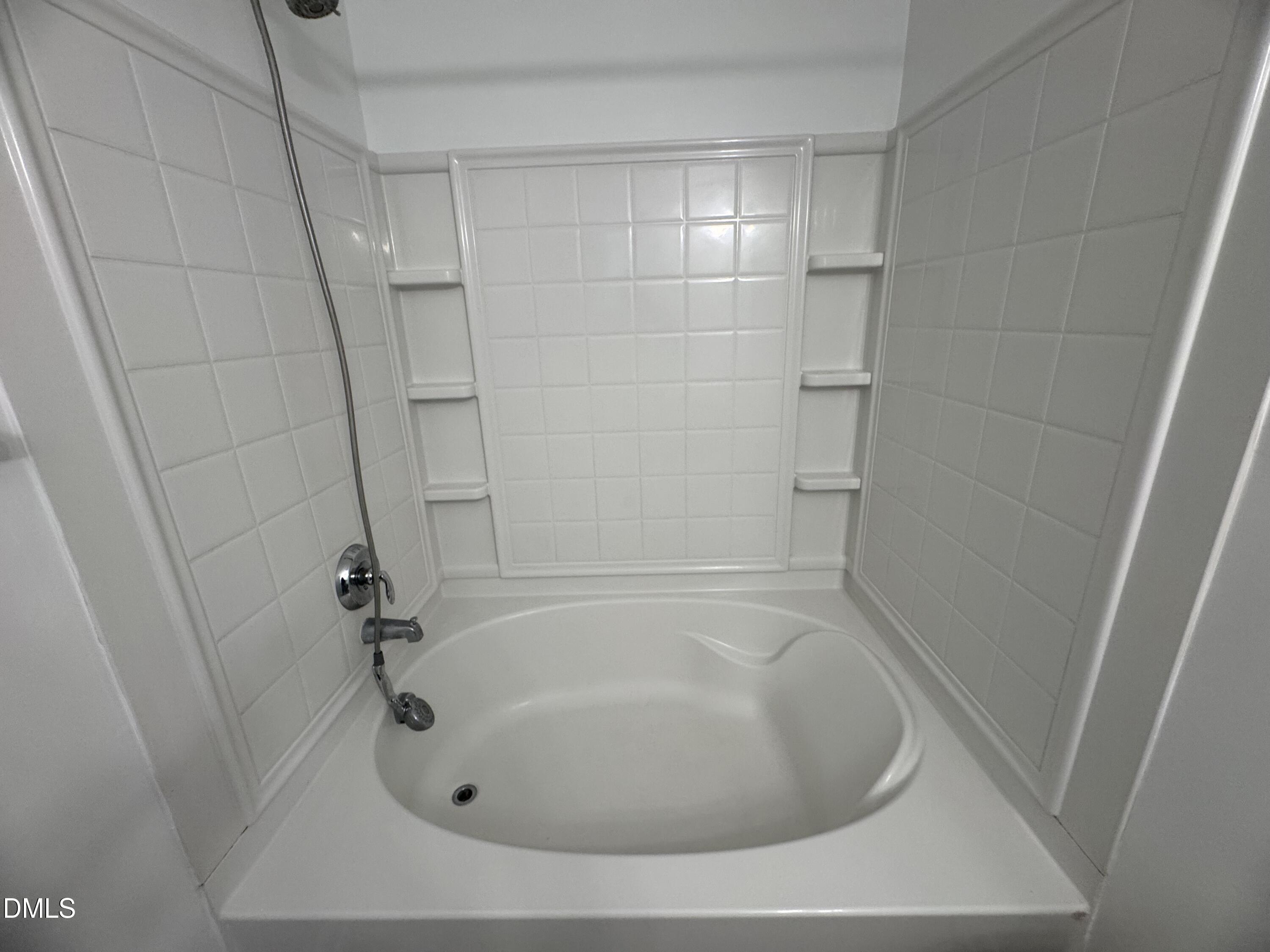 2212 Persimmon Ridge Drive Raleigh, NC 27604 - Photo 10 of 20 a white bath tub sitting in a bathroom