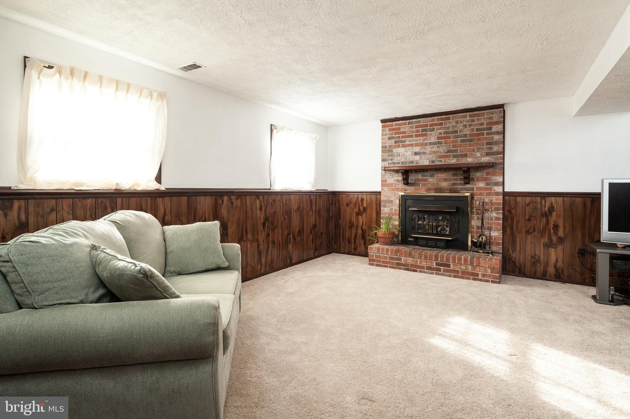 8521 Woodfall Road Baltimore, MD 21236 - Photo 17 of 21 LOWER LEVEL FAMILY ROOM WITH WOODBURNING FIREPLACE