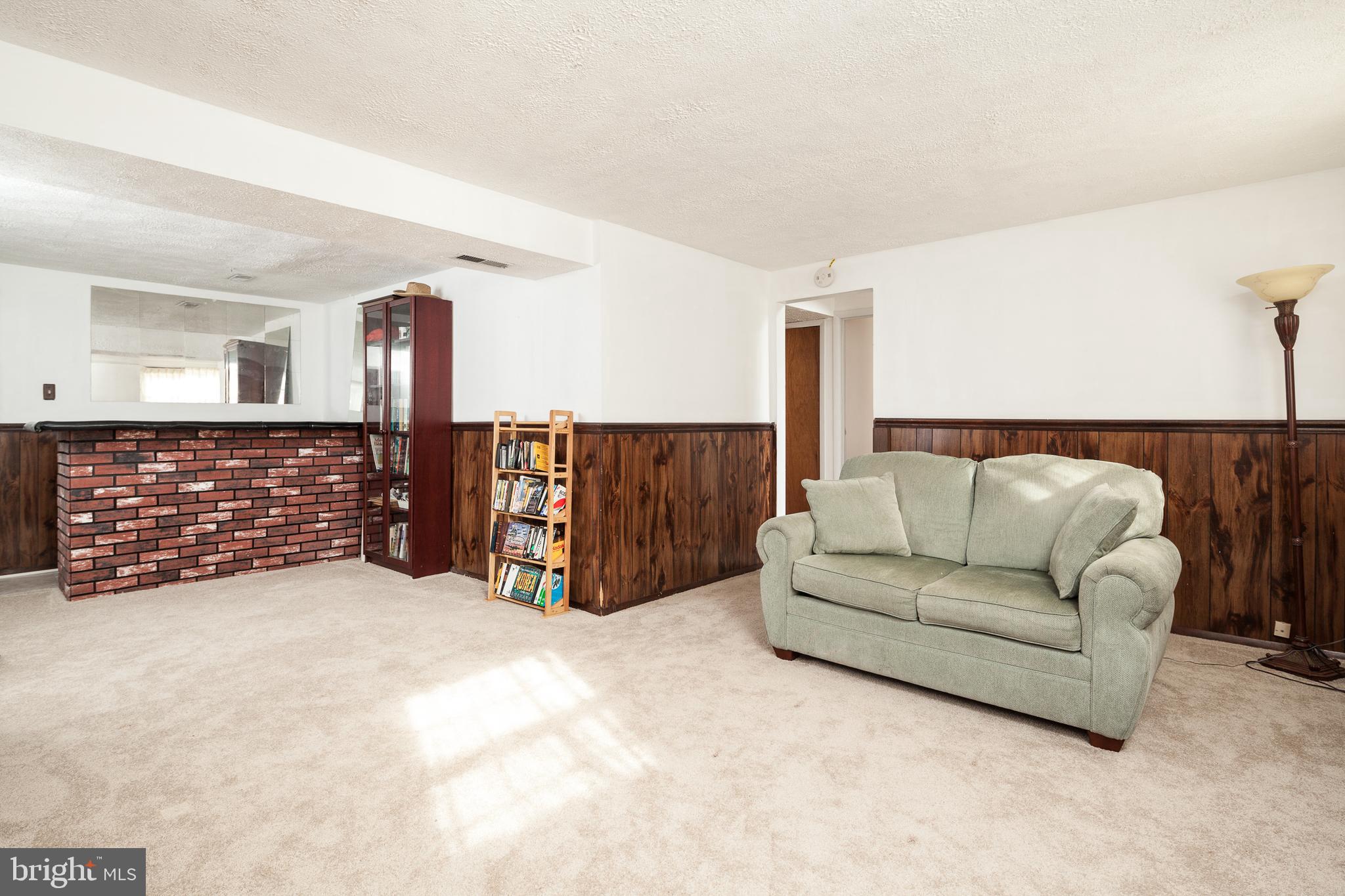 8521 Woodfall Road Baltimore, MD 21236 - Photo 18 of 21 LOWER LEVEL FAMILY ROOM WITH BAR AND EXIT TO REAR