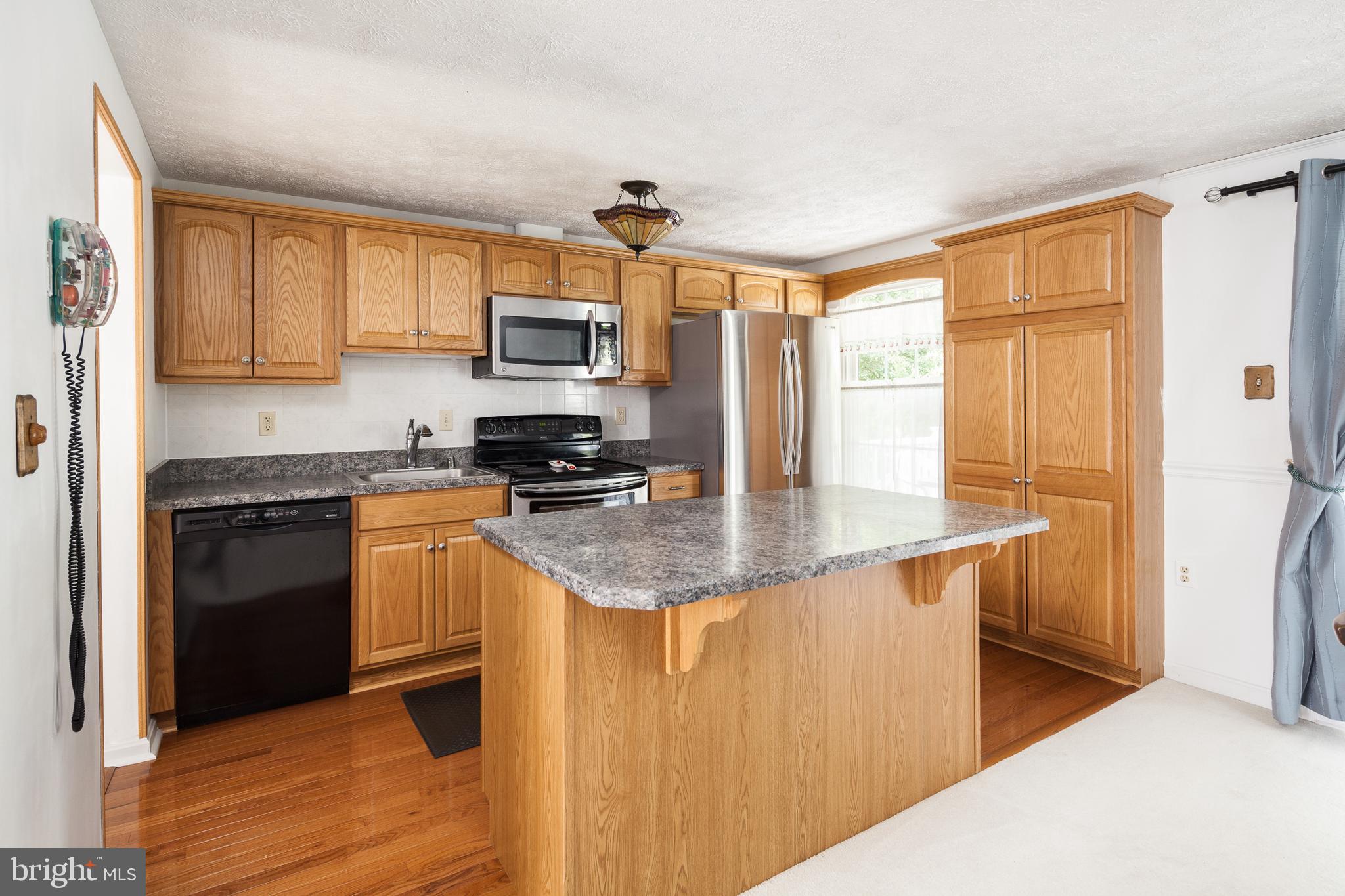 8521 Woodfall Road Baltimore, MD 21236 - Photo 6 of 21 KITCHEN WITH BEAUTIFUL CABINTRY AND HARDWOOD FLOOR