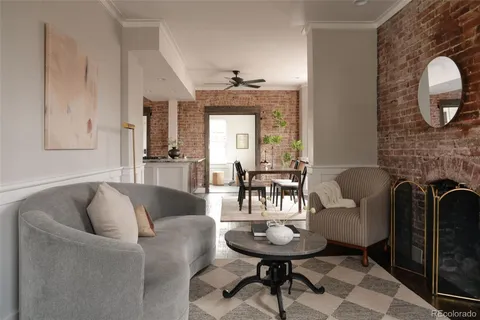 a living room with furniture a fireplace and a chandelier