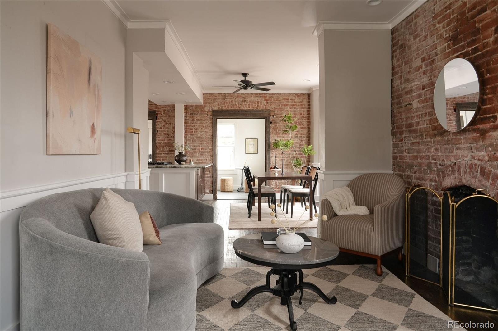 3365 Federal Boulevard Denver, CO 80211 - Photo 12 of 47 a living room with furniture a fireplace and a chandelier