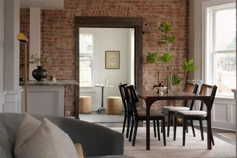 a view of a dining room with furniture and window