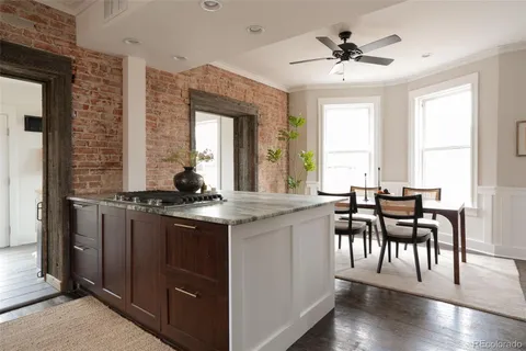 a kitchen with a table chairs stove and cabinets