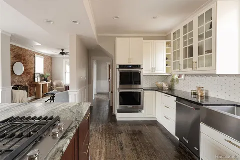 a kitchen with a sink stove top oven and refrigerator