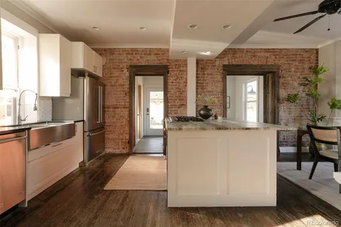 a view of a kitchen with dining table and chairs