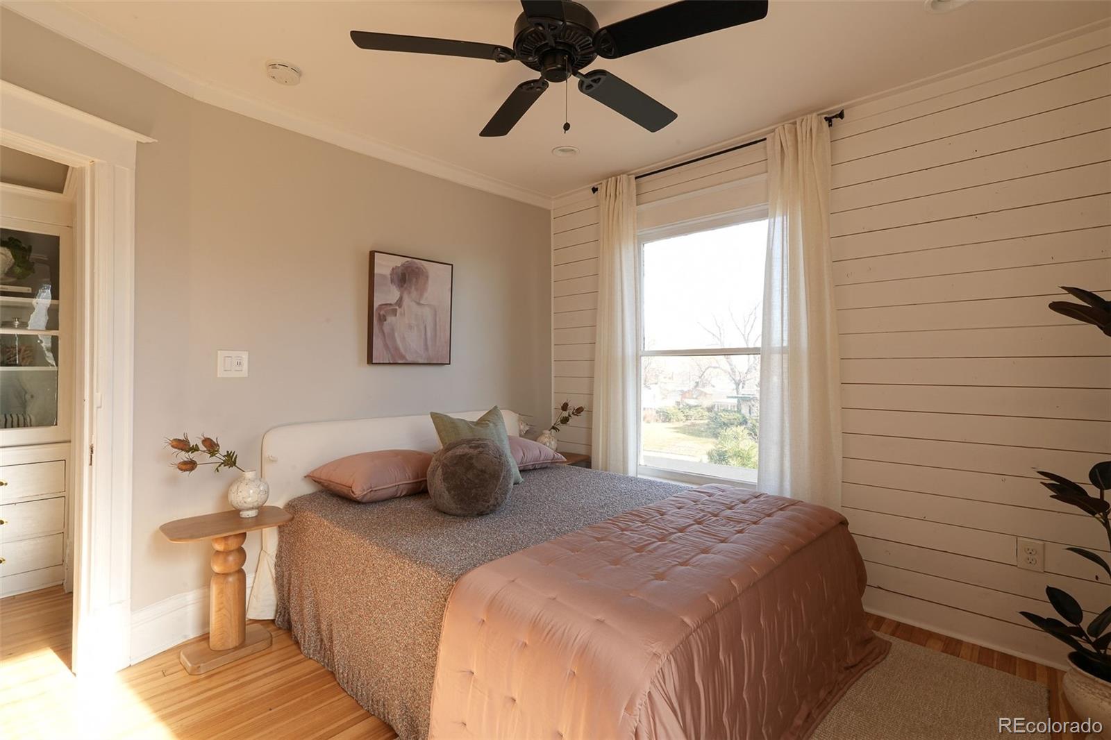 3365 Federal Boulevard Denver, CO 80211 - Photo 27 of 47 a bedroom with a bed and wooden floor