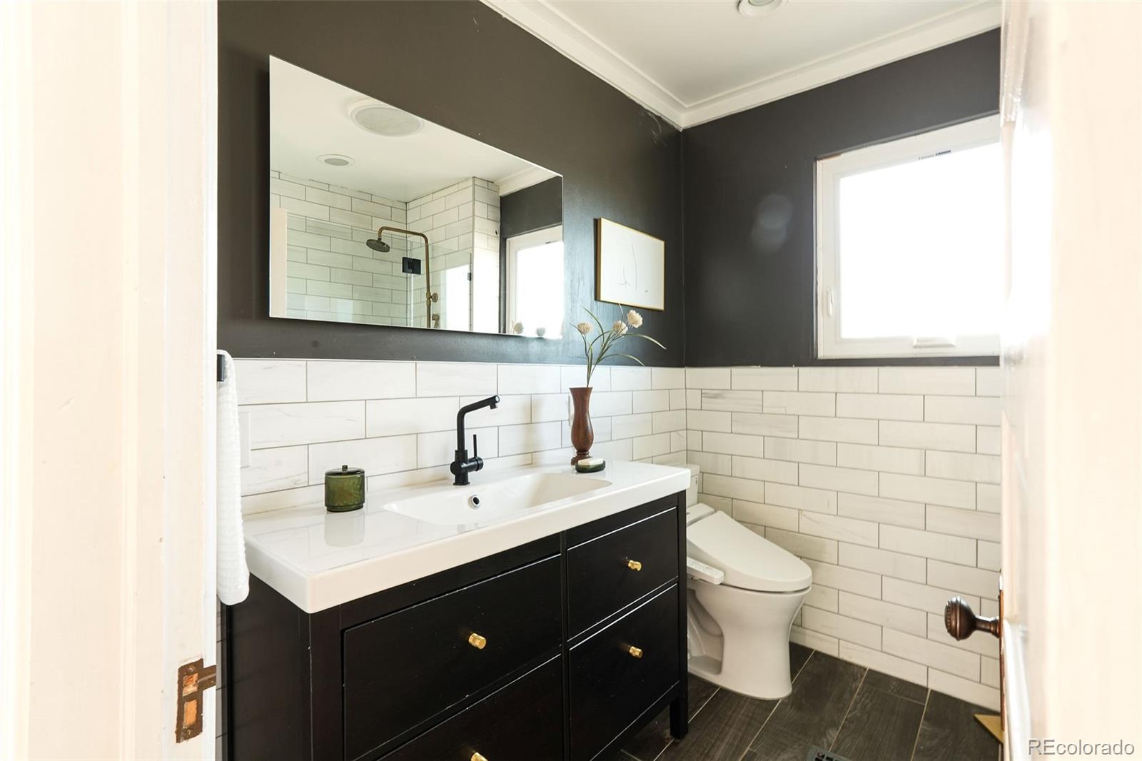 3365 Federal Boulevard Denver, CO 80211 - Photo 29 of 47 a bathroom with a sink mirror and toilet