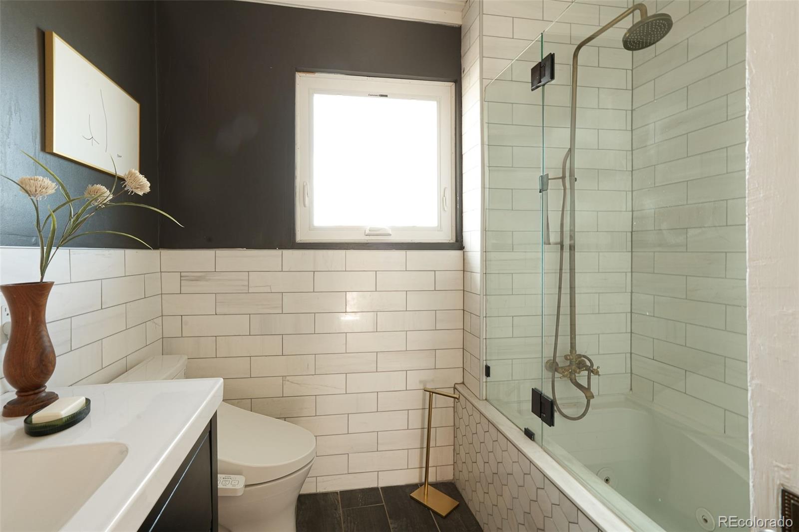 3365 Federal Boulevard Denver, CO 80211 - Photo 30 of 47 a bathroom with a sink a toilet and a mirror